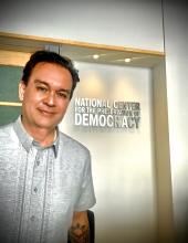 jim herr standing in front of a door with the National center for the preservation of democracy sign on the door